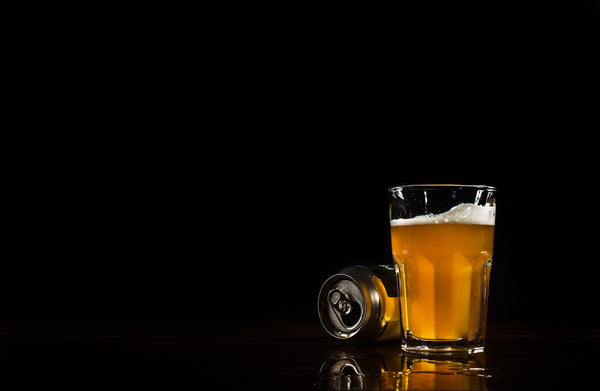 Glass of beer and can of beer